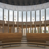 The theatre is framed by a high stone screen that rises to allow clerestory light into the space