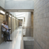 A tough material palette of blockwork and concrete is leavened by timber and brass