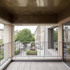 On the top floor, a terrace takes advantage of the building’s slight projection, offering a view down along the line of the terrace