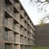 The construction encases conventional, concrete-framed structures inside freestanding, load-bearing masonry walls