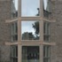 Brickwork is generally flush-pointed with recessed joints at junctions with the precast concrete string courses, entablatures and parapets