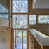 Joinery forms walls of shelving, cupboards and panelling, concealing storage and bathrooms