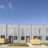 Houses are faced in a grey Equitone cladding
