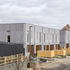 The units are arranged in three curved terraces of eight houses each
