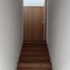 An iroko timber stair leads up to a small platform-sized landing