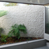 Much of the external wall surfaces are covered in roughly trowelled render, a common local weatherproofing