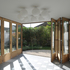 A curtain of timber and glass folding doors wraps the exterior of the house