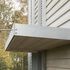 A canopy extends out at first-floor level to shield the interior from the southern sun