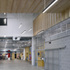 Breeze block walls stop short of the ceiling, the gap closed with a metal mesh that also forms the wall of the shop and information space
