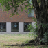 The ground floor of the building is articulated with a concrete base that acts as a register of the site topography
