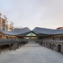 The project consists of two elongated Victorian warehouses, converted into a high-end shopping centre and connected via a dramatic curved roof