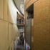Triple height space between compressed auditorium and its original wall