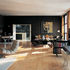 The first floor living room with maple floor, view towards staircase