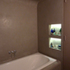 Radiused plasterwork softens wall plane, creating carved space for the bath and inset niches