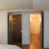 Master bedroom with paired doors to the shower room and lower hallway 