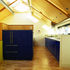 Kitchen seen from dining area with the view down to the living area on the left