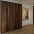 Sliding partition (extended) conceals the living space beyond and reveals the white washed alcove lining