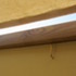 The cotton canopy is held in tension above the doors when open, and wound up and hung in the 