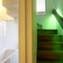 The bathroom is neatly concealed under the stairs