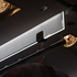 The bespoke clothes rail arrangement was based on a sliding glass door mechanism. The glass ‘door’ in effect was cut short, to create a suspended glass ‘fin’ onto which a polished stainless steel pole was attached below it.