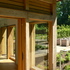 Views through large sheets of glass, of the idyllic landscape are framed by robustly sized oak surrounds, which convey to the occupants a powerful sense of enclosure and protection from the elements.
