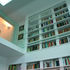 The double height bookshelf provides extensive book storage