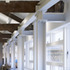 Glazing is hung from the new steel frame which supports the listed trusses