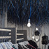 The clothes rails use the same palette of materials as the tables, with broom handles for rails