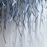 A tangled series of linear shadows are cast onto the surrounding walls