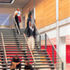 Ground floor entrance concourse, with glazed ceiling to forum above. Intense colours integrate with the exposed concrete and timber panelling to create a glowing space
