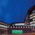 The building at night. The coloured windows are vitrines for information posters.