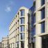 The facade uses a combination of different shades of handmade bricks