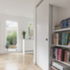 View from the hallway through the widened opening to the kitchen/dining space beyond