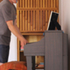 Checking piano with drinks unit to rear; serving surface denoted by inverted pyramid angles forming arrow, thereby placing emphasis on hinge point.
