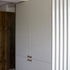 Mimicry of conventional tongue and groove wainscotting achieved via automated cutting.  Photo illustrates entrance hierarchy; front of house to dining room left, and back of house to side garden entrance, right.