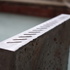 Struck concrete shelf.  Edge detail in response to on-angle brickwork infilled between timbers opposite.