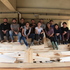 The workshop team sitting on the CNC-milled lattice pieces prior to assembly 