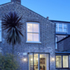 External View: Dusk view of the renovated kitchen from the rear garden