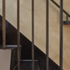 Loft Stair: Detail view of folded steel stair treads, with rough plaster feature wall behind