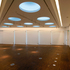 Slanting truncated cones provide daylight and ventilation to the upper gallery space