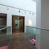 First floor suspended walkway leads from old building to new touring exhibition gallery