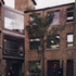The courtyard looking towards the narrow entrance and the glazed bridge link above