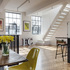 View from dining area to white metal stairs