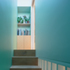 Daylight from a frameless glazed roof animates the stairwell with constantly changing hues