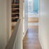 A shoe rack is nestled at the first landing to the flat proper, with a bedroom doorway adjacent