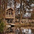 all in the trees_ tree house and walkway view from across the lake