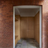Original side entrance with a brick arch above. 
