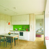 The kitchen with window seat and the living room beyond