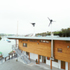 Covered walkway and extended roof used to guide wind over courtyard