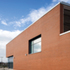 A robust red brick is used throughout the building